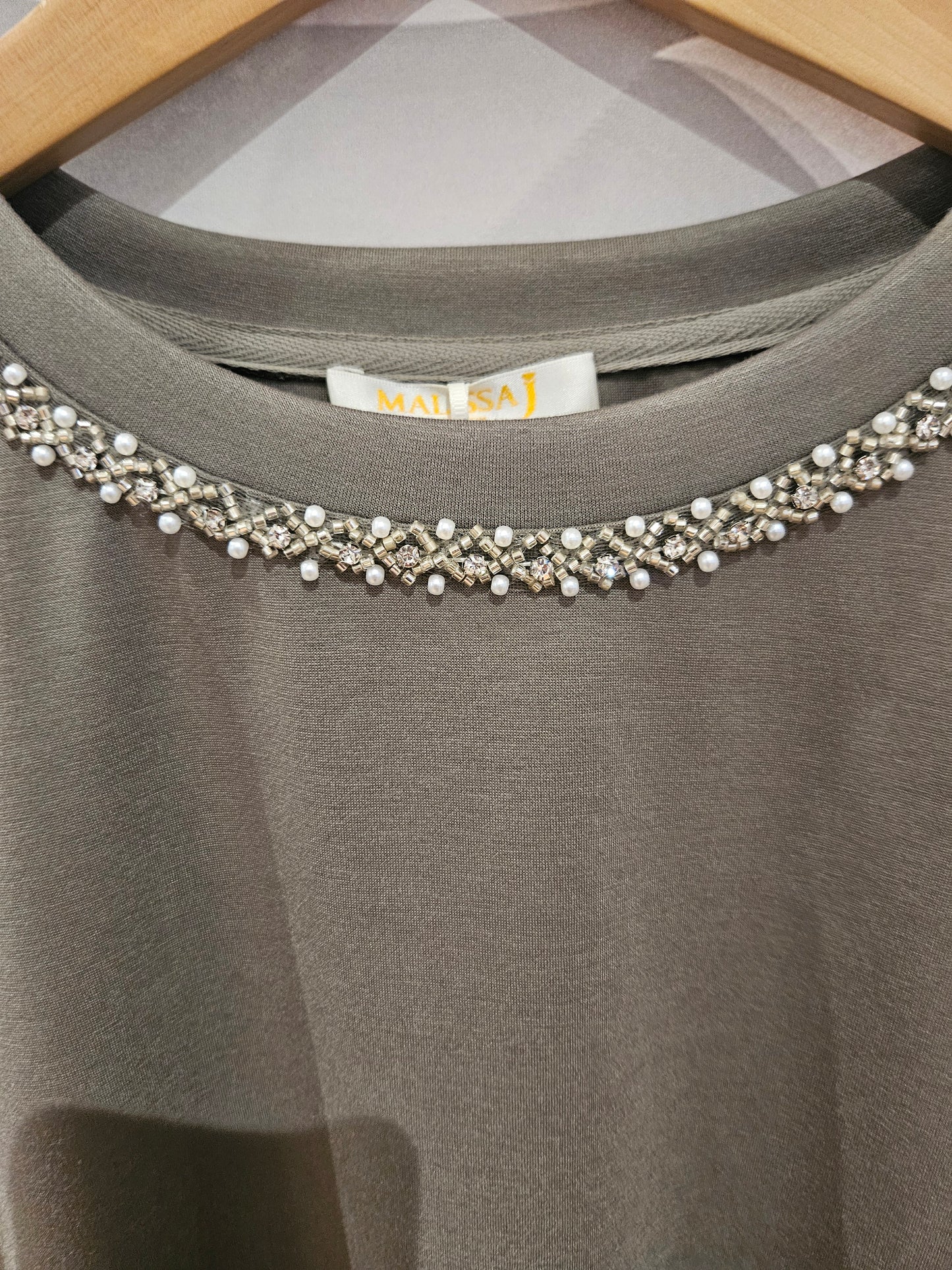 Tiered Hemline Top with Embellishment Detail